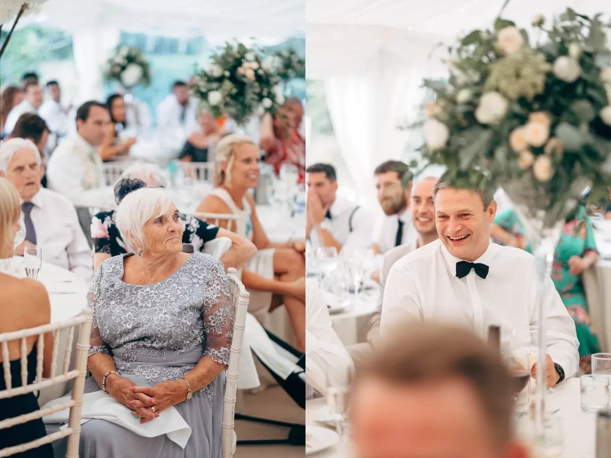 Guests sit at tables in a bright, elegant wedding reception. On the left, an elderly woman in a silver dress smiles. On the right, a man in a white shirt and black bow tie laughs among friends. Floral centerpieces decorate the tables.