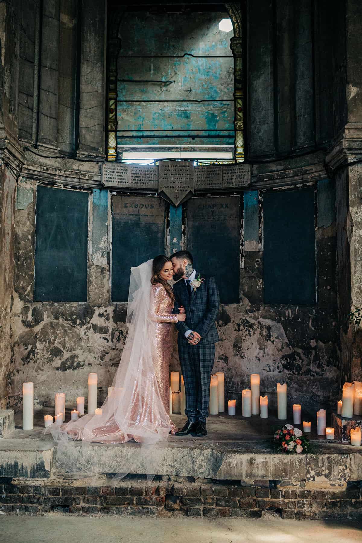 bride in pink sequin wedding dress standing at alter in asylum chapel peckham for the cover of rock n roll bride magazine