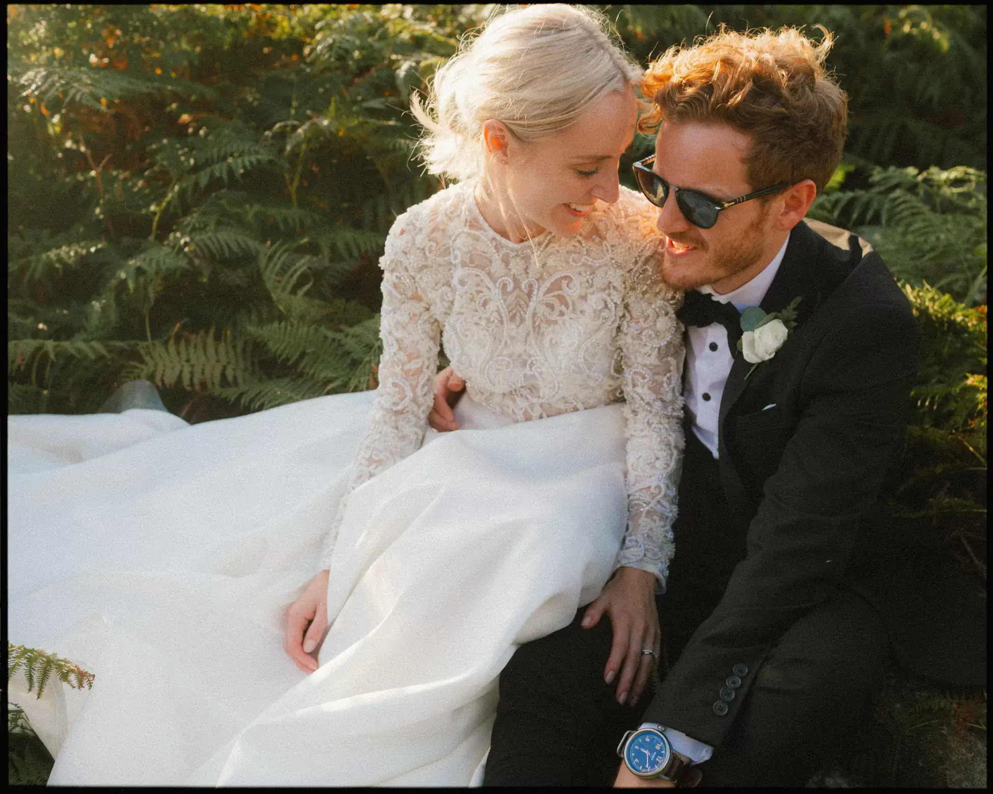 Kent Woodland Wedding Photographer - couple sat in ferns with sunset