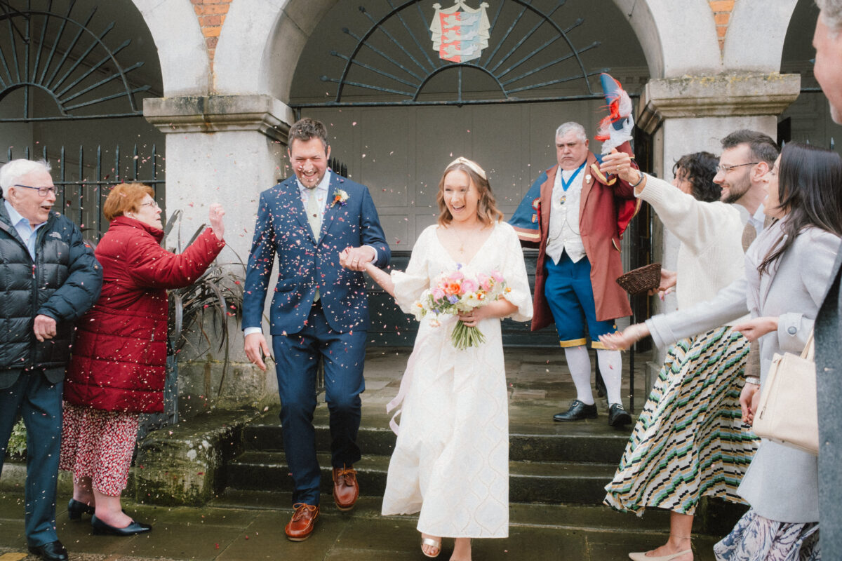 Tibbs Farm wedding - couple with confetti and town crier at rye town hall