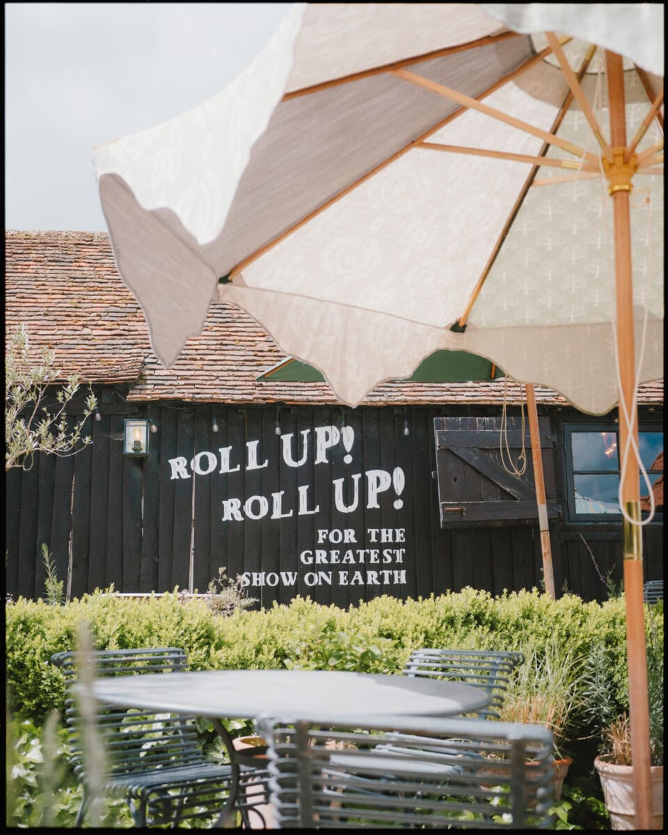 Circus sign reading “Roll Up! Roll Up! For the Greatest Show on Earth” at Preston Court wedding venue in Kent.