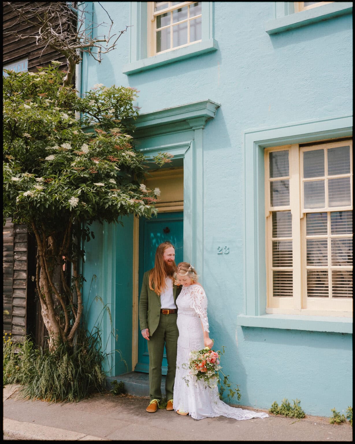 bride and groom standing in rock a nore hastings old town on the way to their wedding at the cove in fairlight