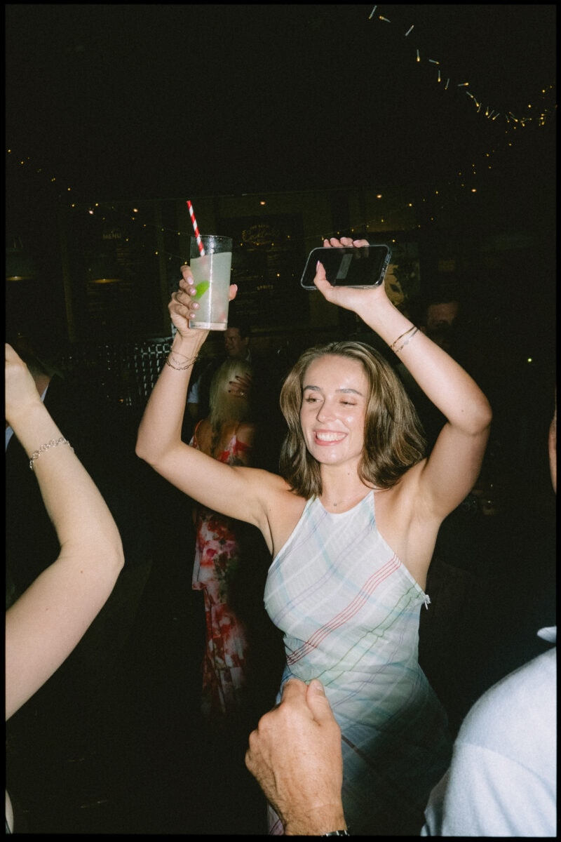 The Depot N7 wedding photographer London — guest dancing and holding glass on dancefloor