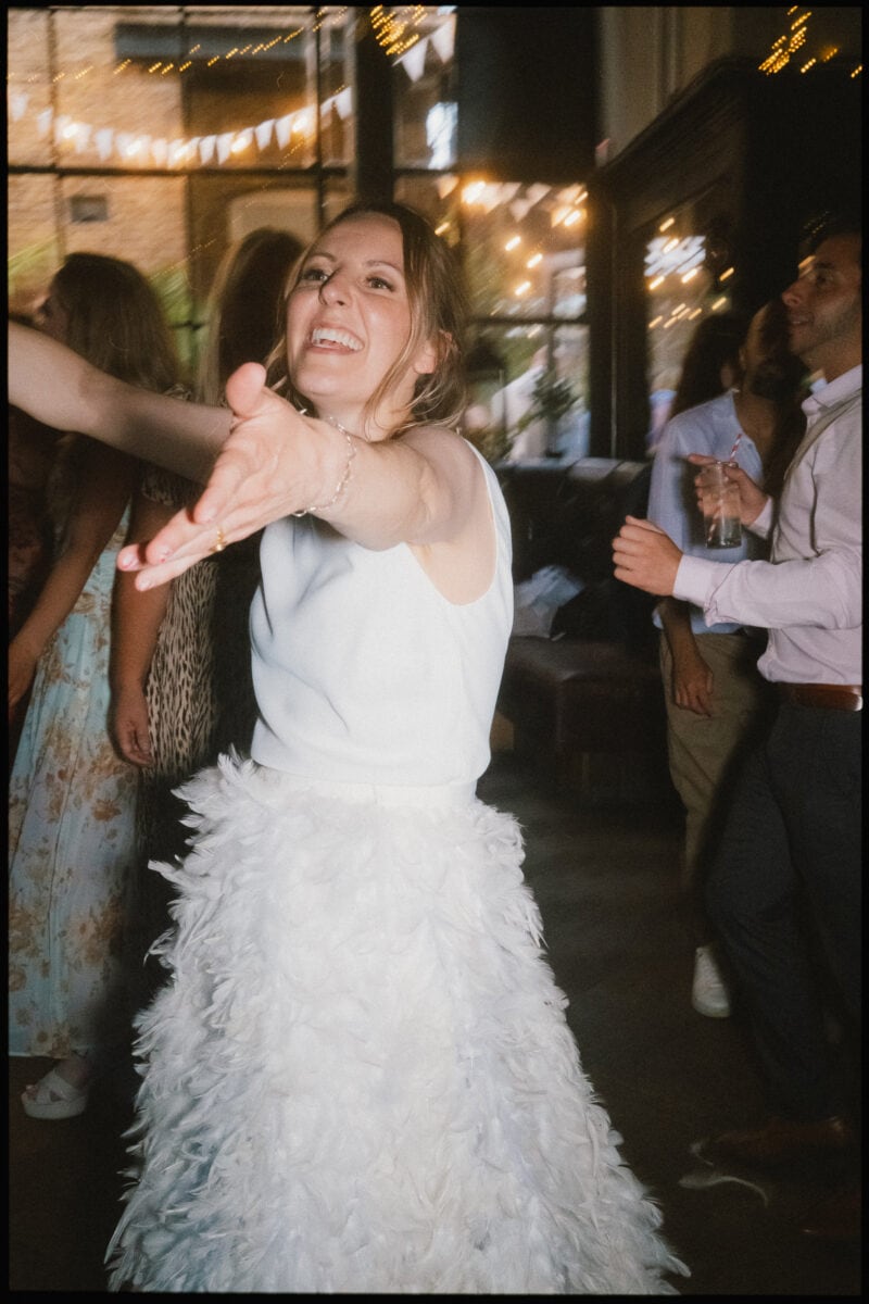 The Depot N7 wedding photographer London — bride hugging on dancefloor