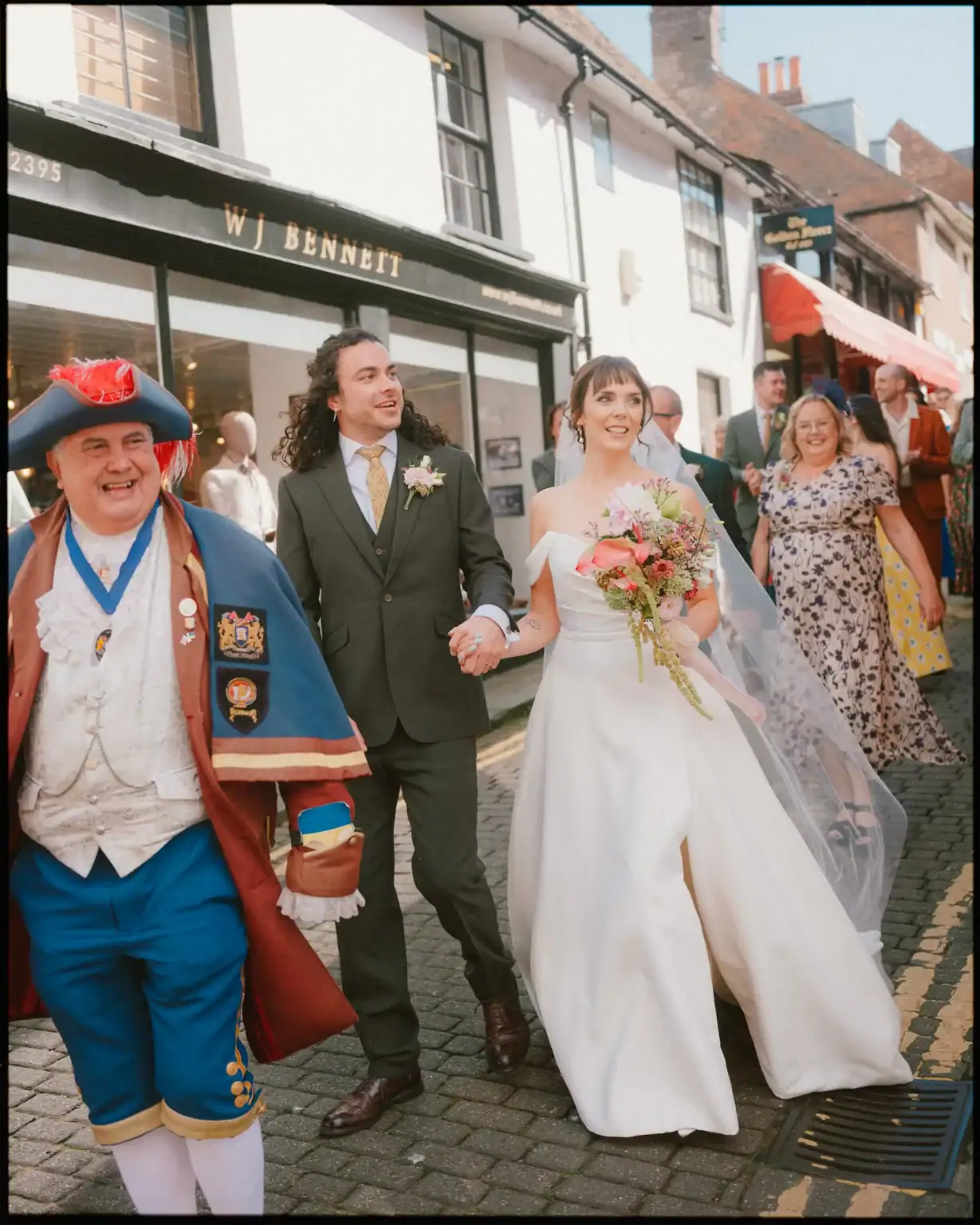 bride and groom arriving at the george in rye after their town hall ceremony with the town crier