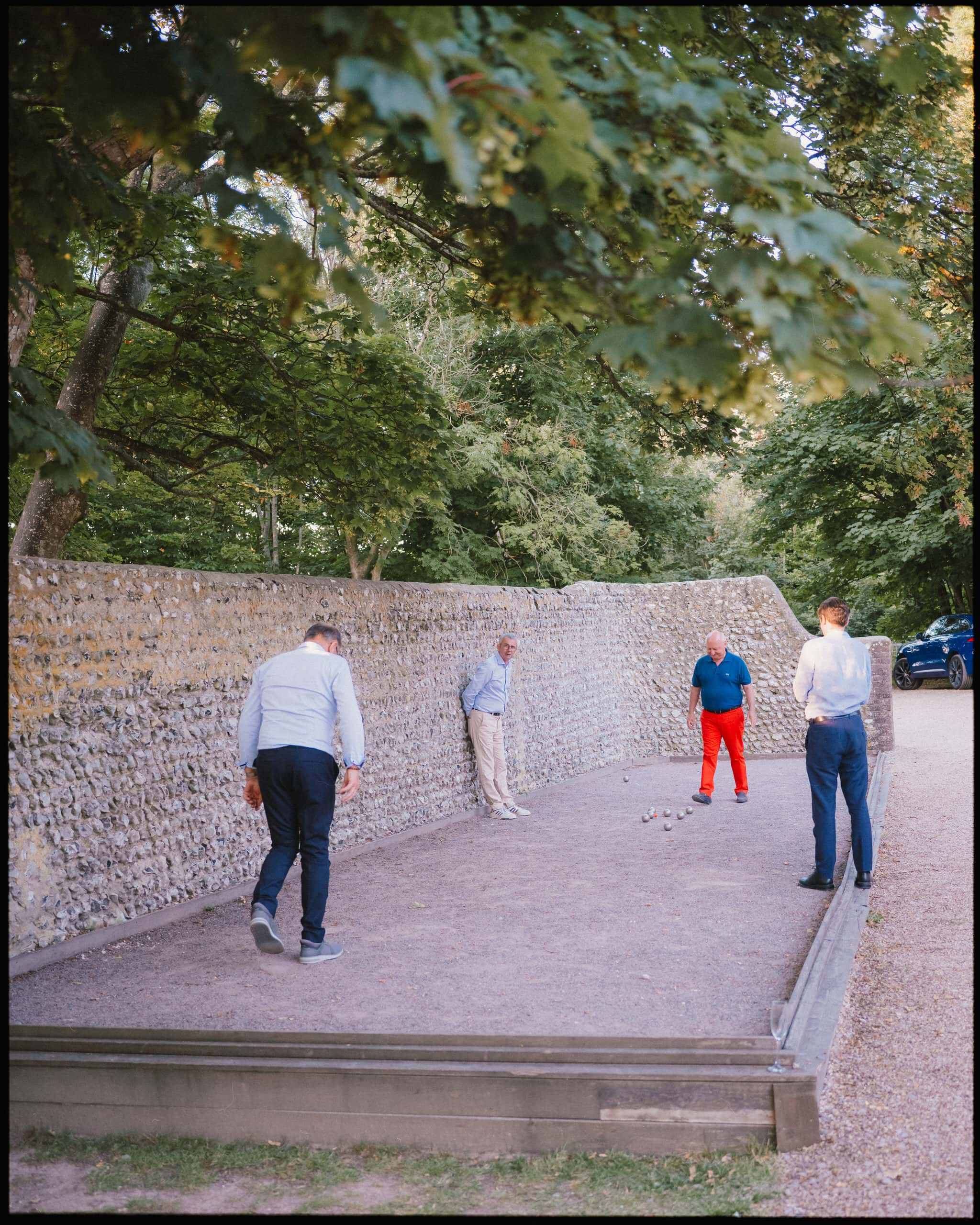 Guests playing pétanque during evening at Cissbury Barns wedding venue in Findon, West Sussex.