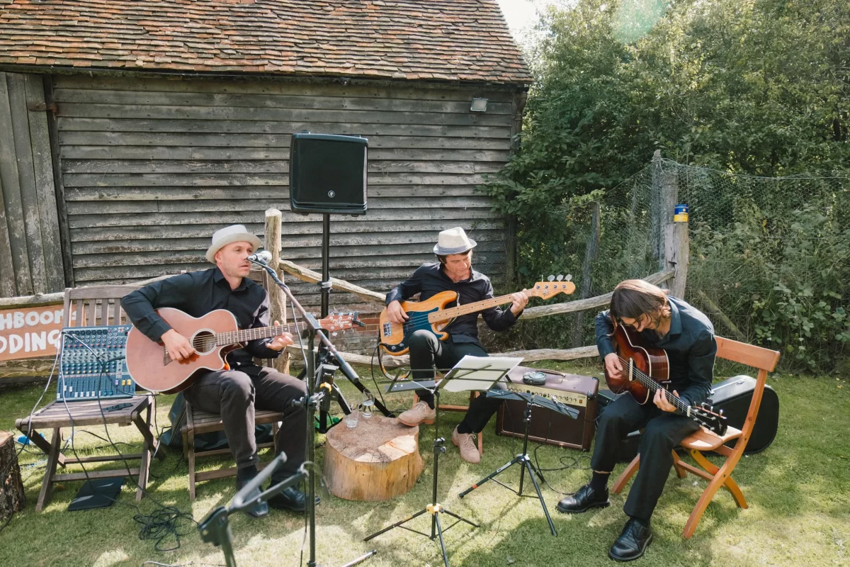 band playing for guests during cocktail hour at exclusive woodland wedding venue paper mill kent