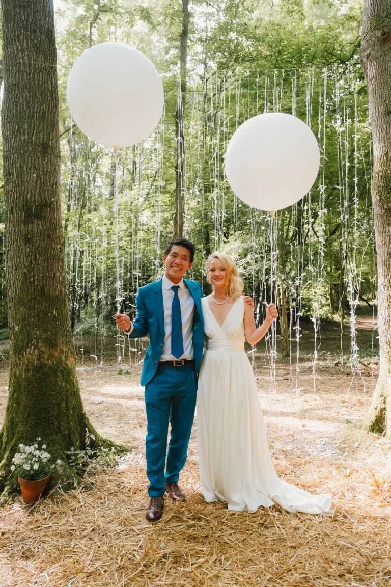 bride and groom with balloons exclusive woodland wedding venue paper mill kent