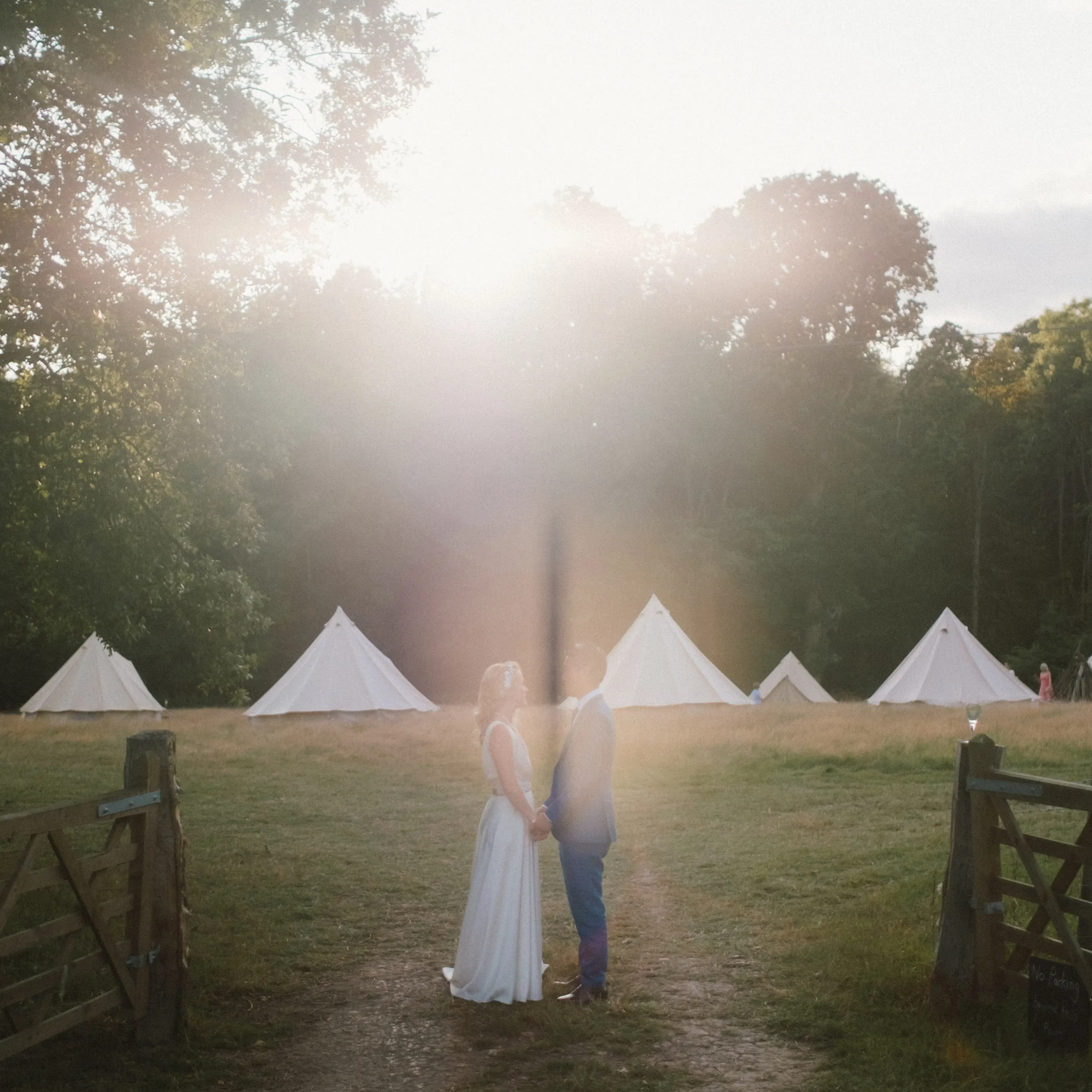 bride and groom in front of tents at exclusive woodland wedding venue paper mill hawkhurst kent