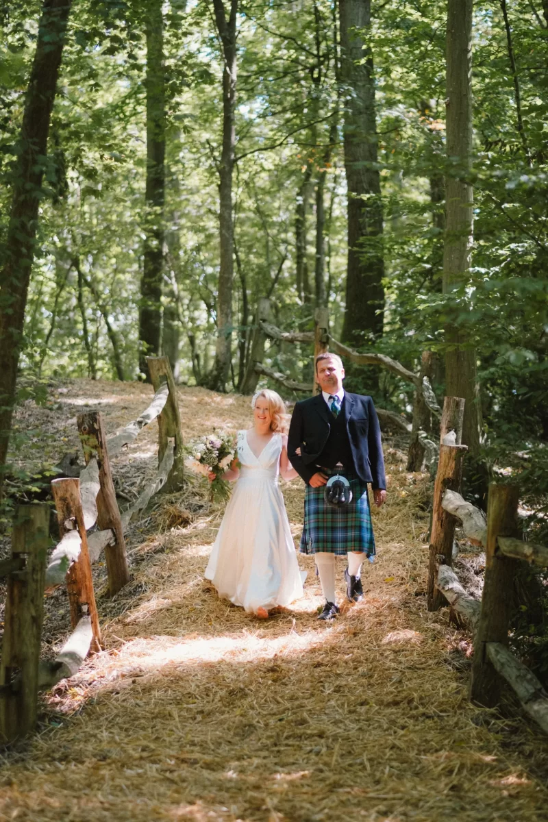 bride walking down to ceremony exclusive woodland wedding venue paper mill kent
