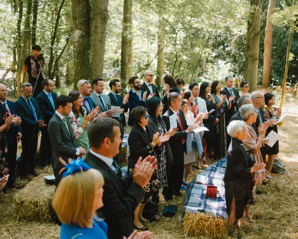 guests celebrating and clapping at exclusive woodland wedding venue paper mill kent