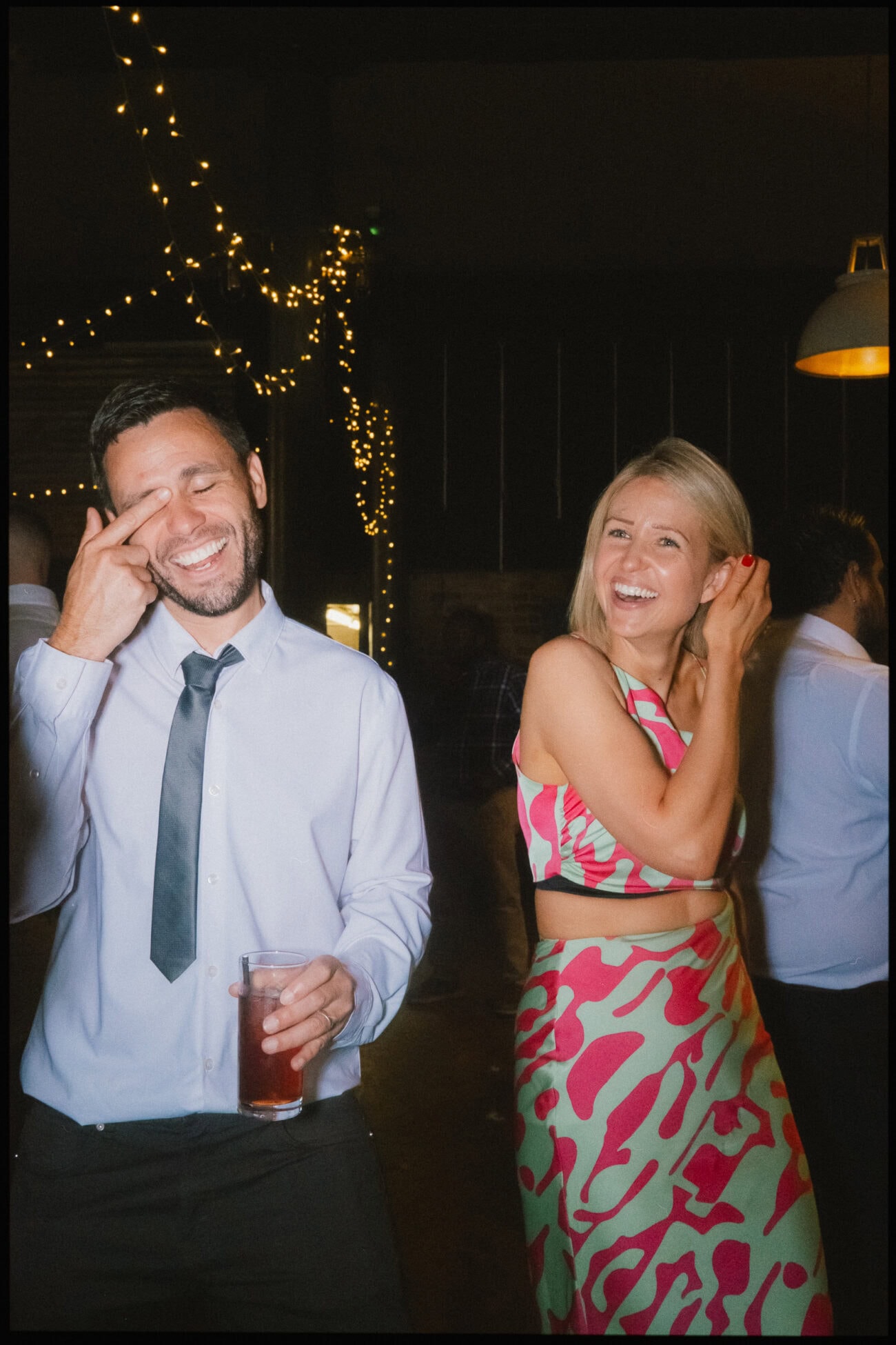 Big laughs and recovery moments on the dance floor — guests enjoying the evening reception at The Depot N7 in London. Wedding guests smiling and laughing on the dance floor during the evening reception at The Depot N7 in London.