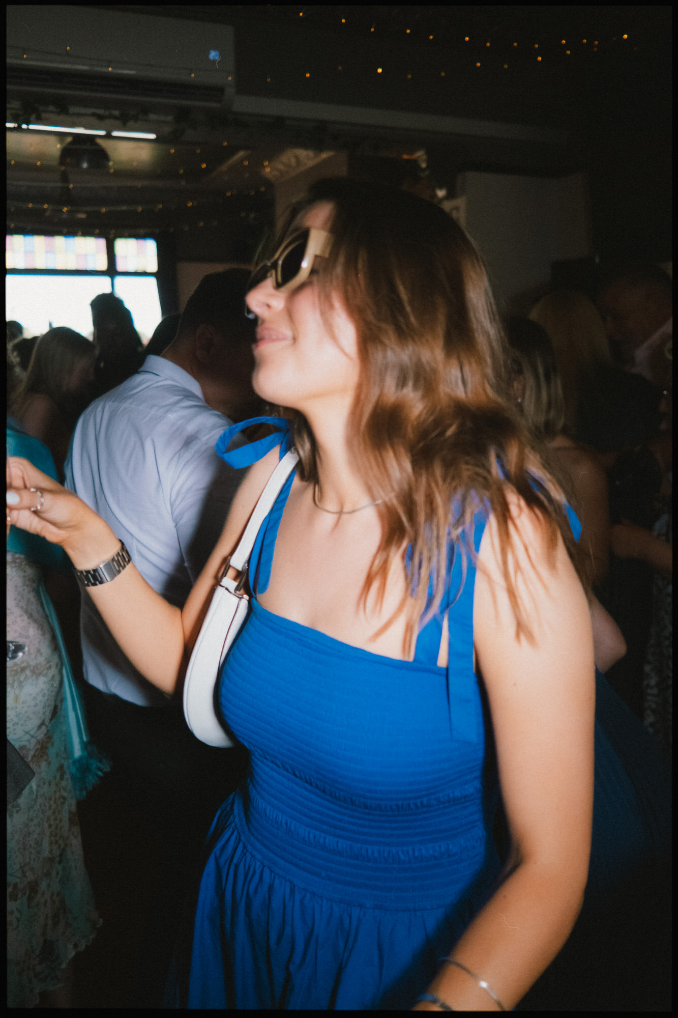 London wedding Photographer - guest dancing in sunglasses direct flash
