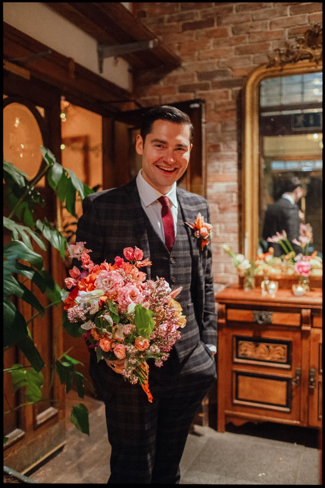 clapton country club wedding photographer London - groom holding flowers