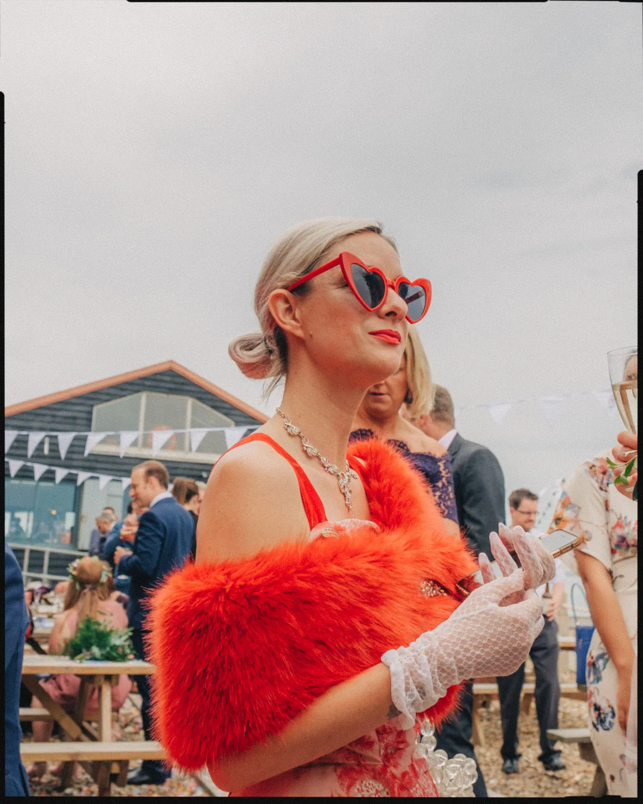 east quay wedding photographer whitstable kent - guest on beach in red sunglasses