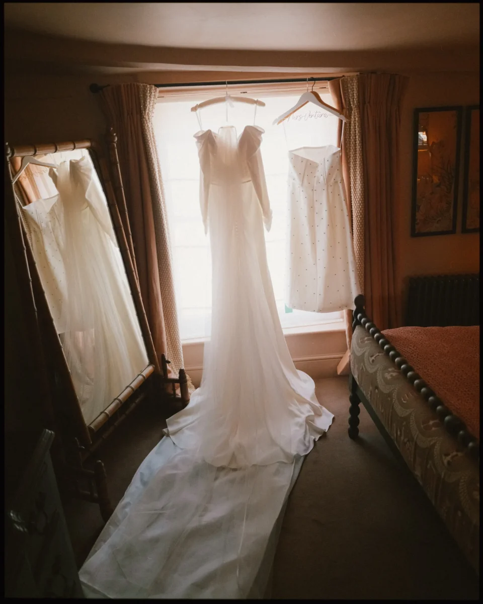 george in rye wedding photographer brides dress hanging in the window