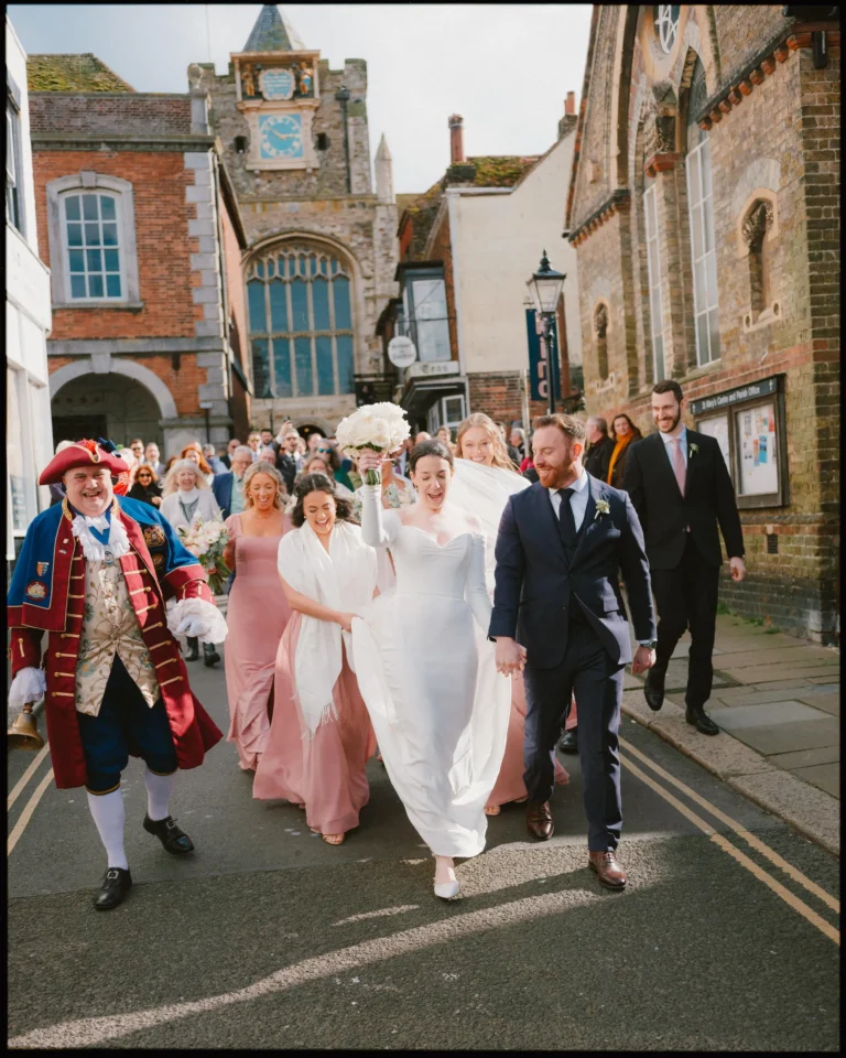 george in rye wedding photographer town crier parade with couple down the street
