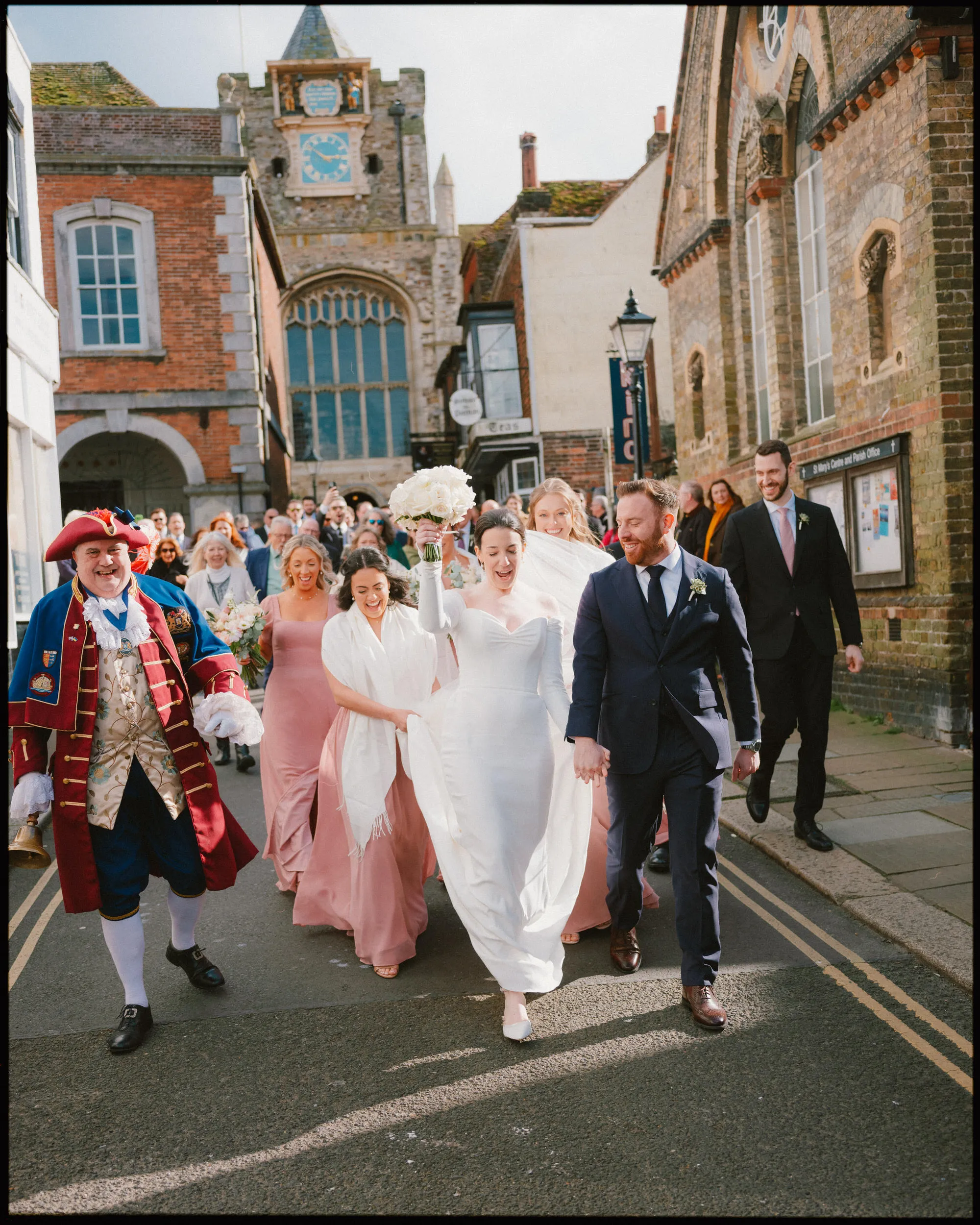 george in rye wedding photographer town crier parade with couple down the street