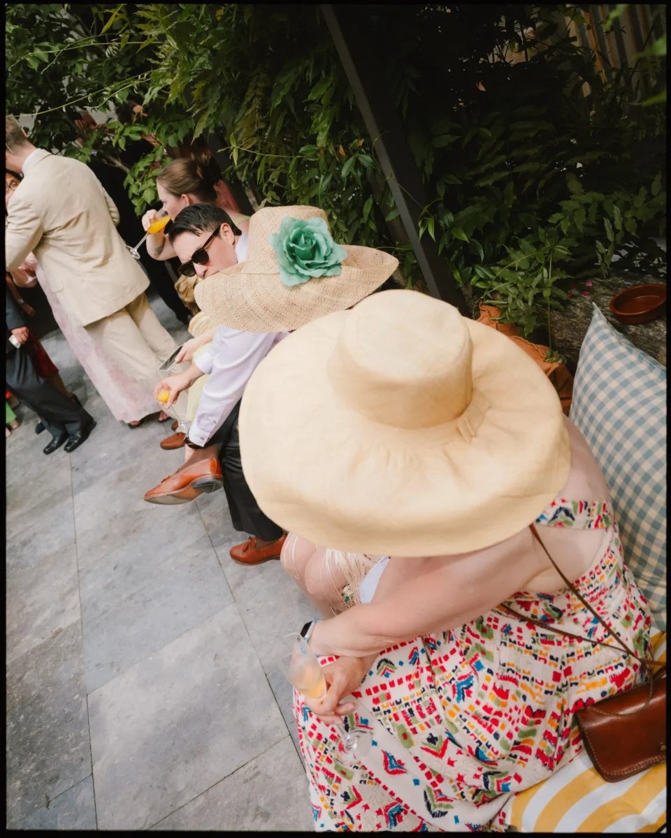 Fujifilm GFX100RF wedding photograph — big hats at cocktail hour