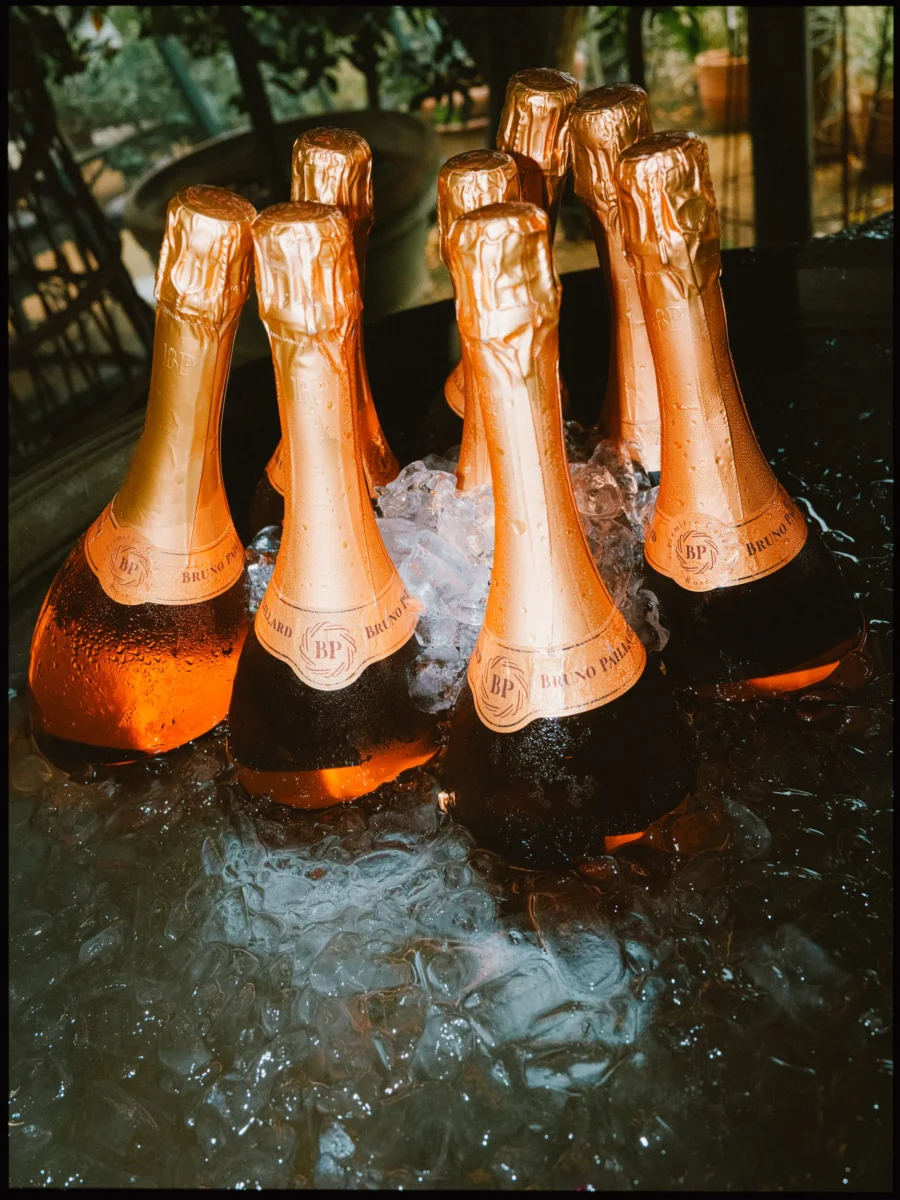 Copper-foiled Bruno Paillard bottles beaded with condensation in an ice tub at Petersham Nurseries