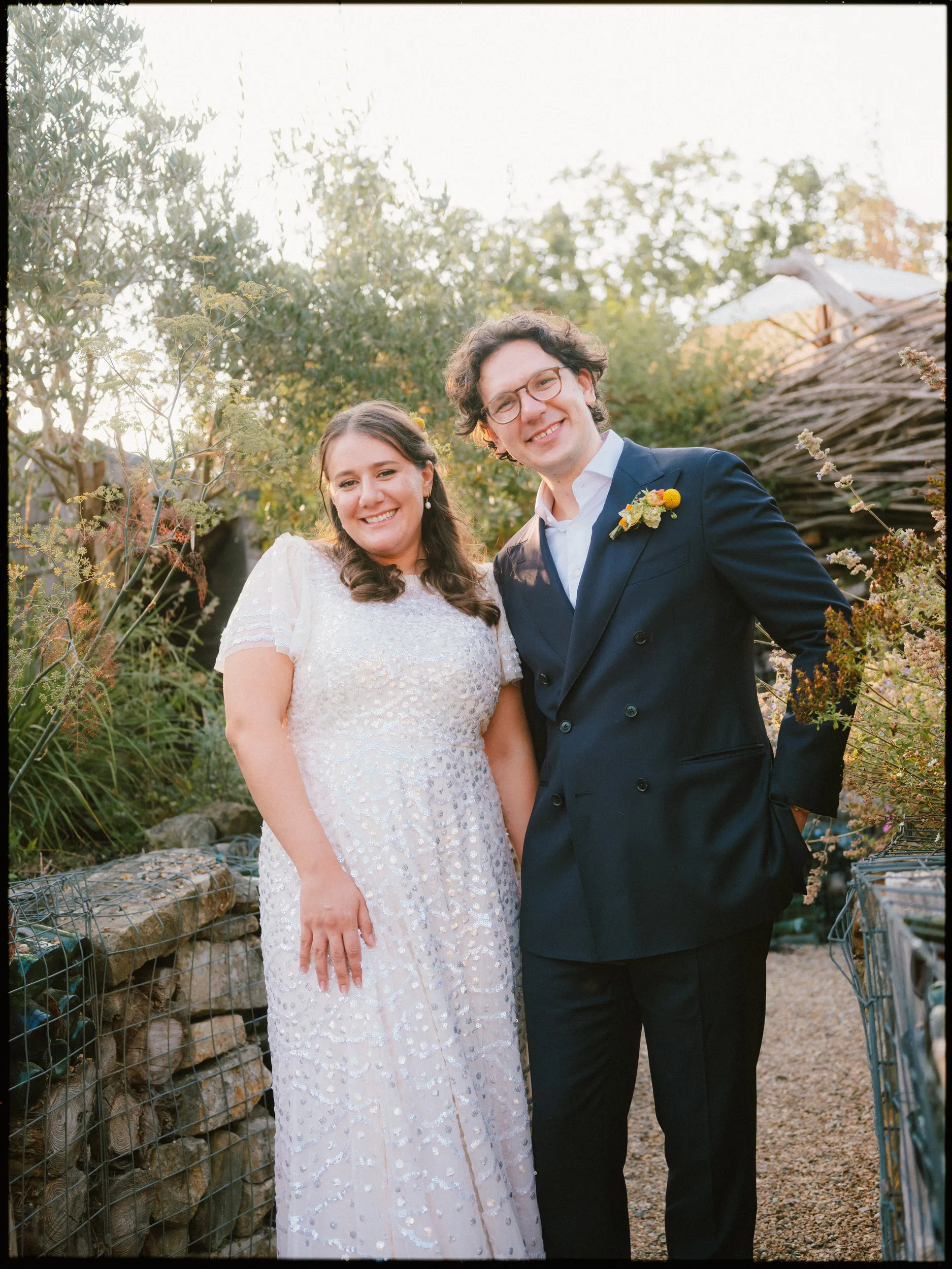 the bell in ticehurst wedding photographer - couple in the garden by the lodges and fire pit